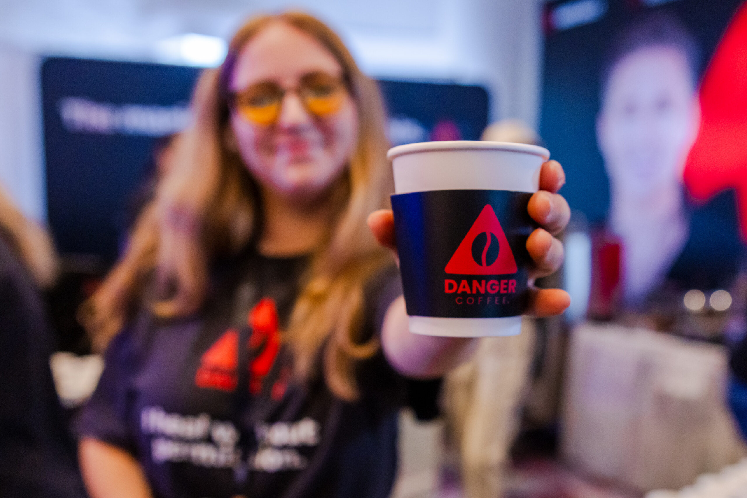 Woman holding a cup of danger coffee