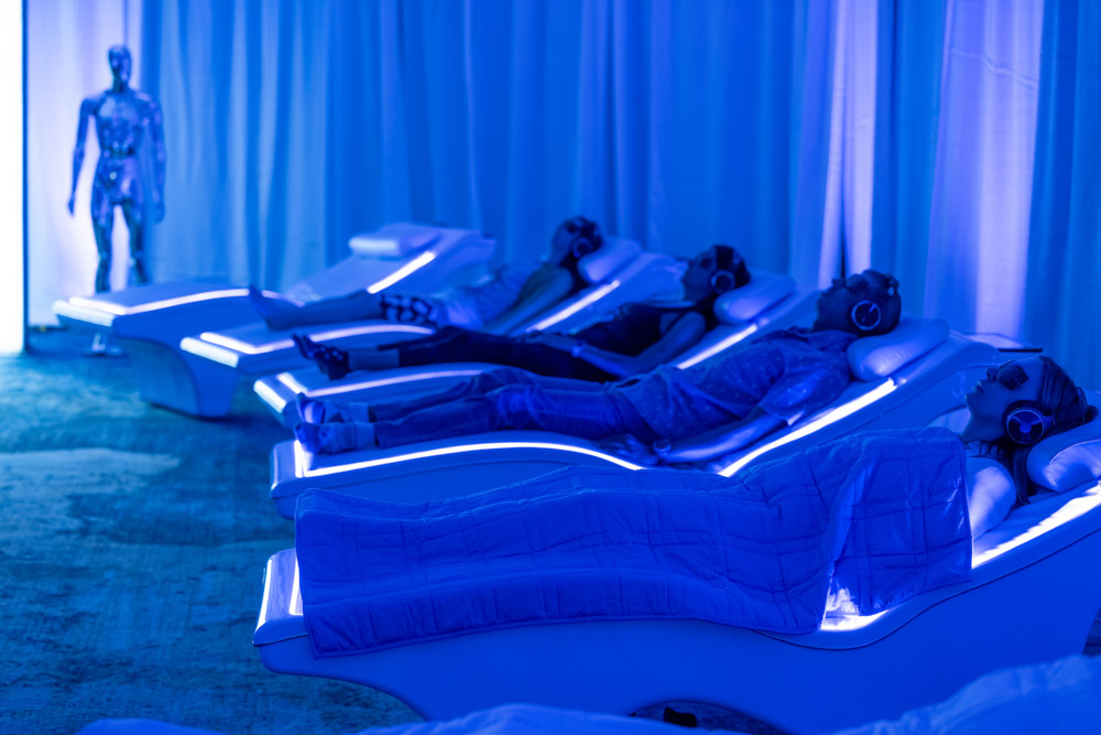 row of people lying in tech bed for Biology & Longevity