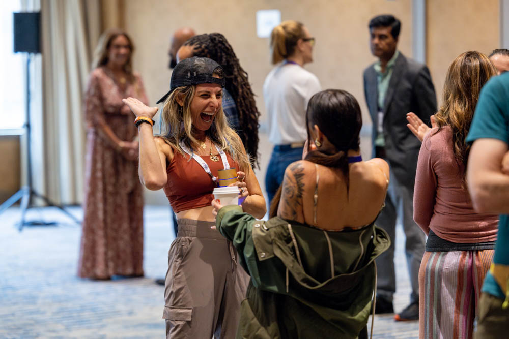 Two women laughing over coffee