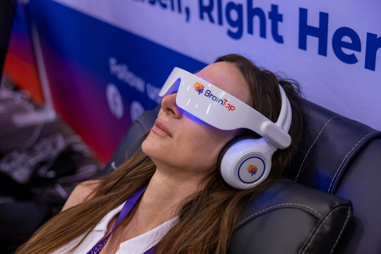 woman with braintap googles/headset on to experience Consciousness & State