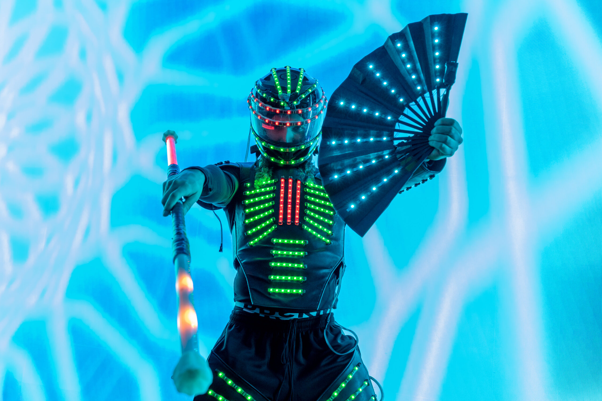 Dancer in LED costume holding a fan